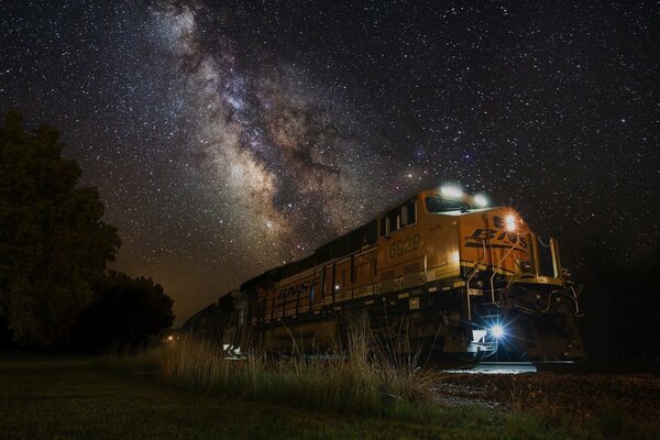 A night train is going, and the Milky Way is in the sky