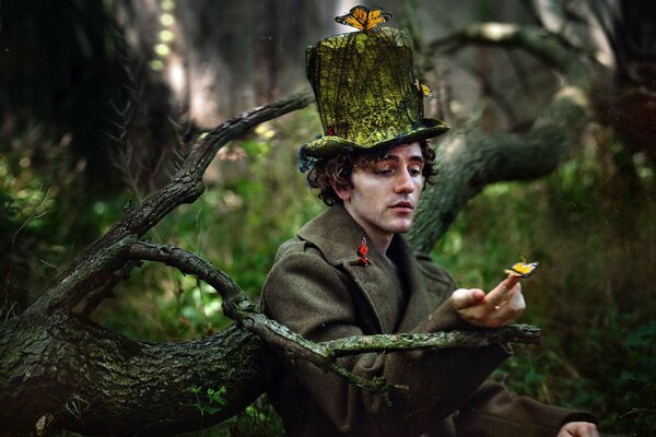 A man in a hat in the forest with butterflies