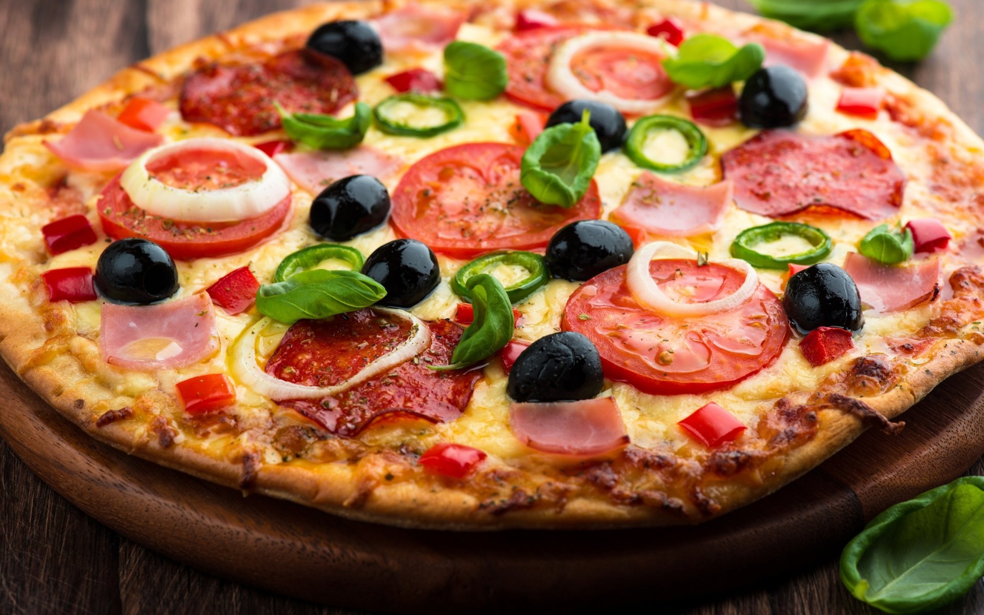 pizza tomatoes cheese olives sausage ham crust dish table board green appetizing delicious fragrance food