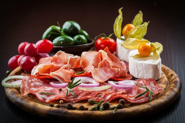 Still life of sausage cheese and vegetables