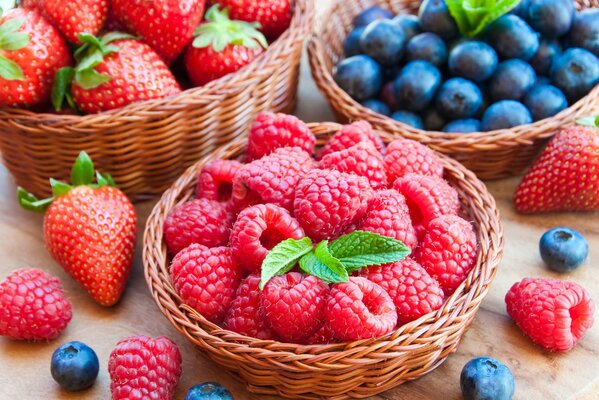 Raspberries and blueberries in a wooden basket