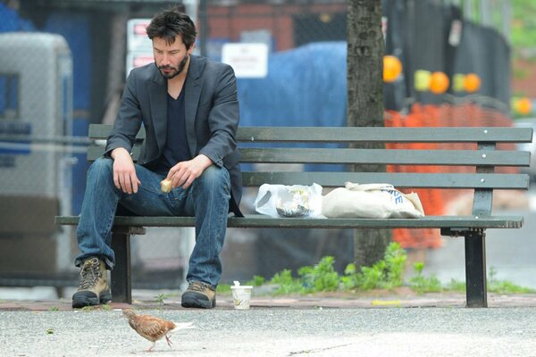 Sad Keanu Reeves on a park bench