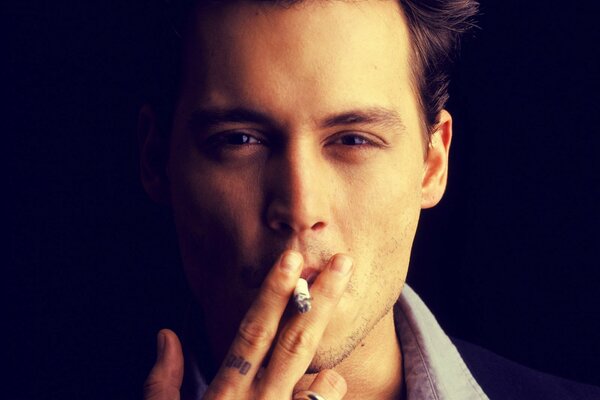 Johnny Depp smokes a cigarette