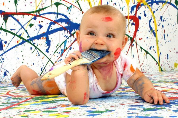 A beautiful baby got dirty in paint