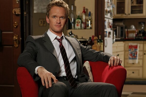 Attore Patrick Harris sulla sedia rossa