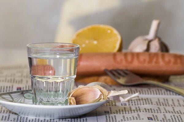 Faceted glass of vodka with a snack