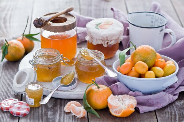 Still life tangerine jam on a tray and tangerines