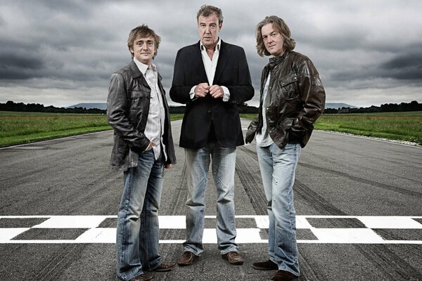 Three on a deserted road in the middle of a field