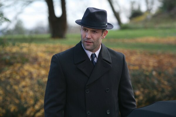 Jason Statham in cappello e cappotto