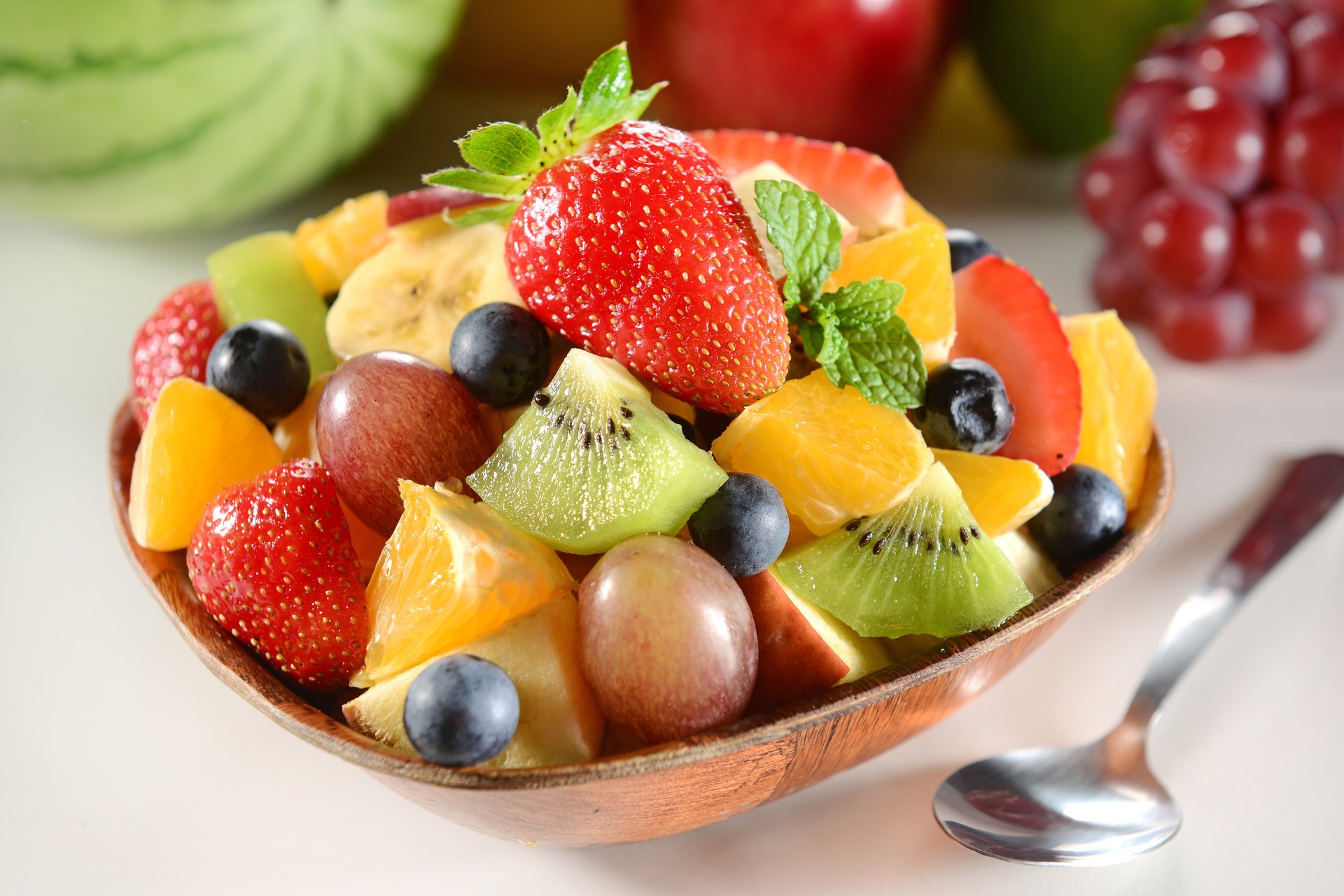 dessert fruit salad kiwi strawberry blueberries grapes mint leaves berries bilberry grape