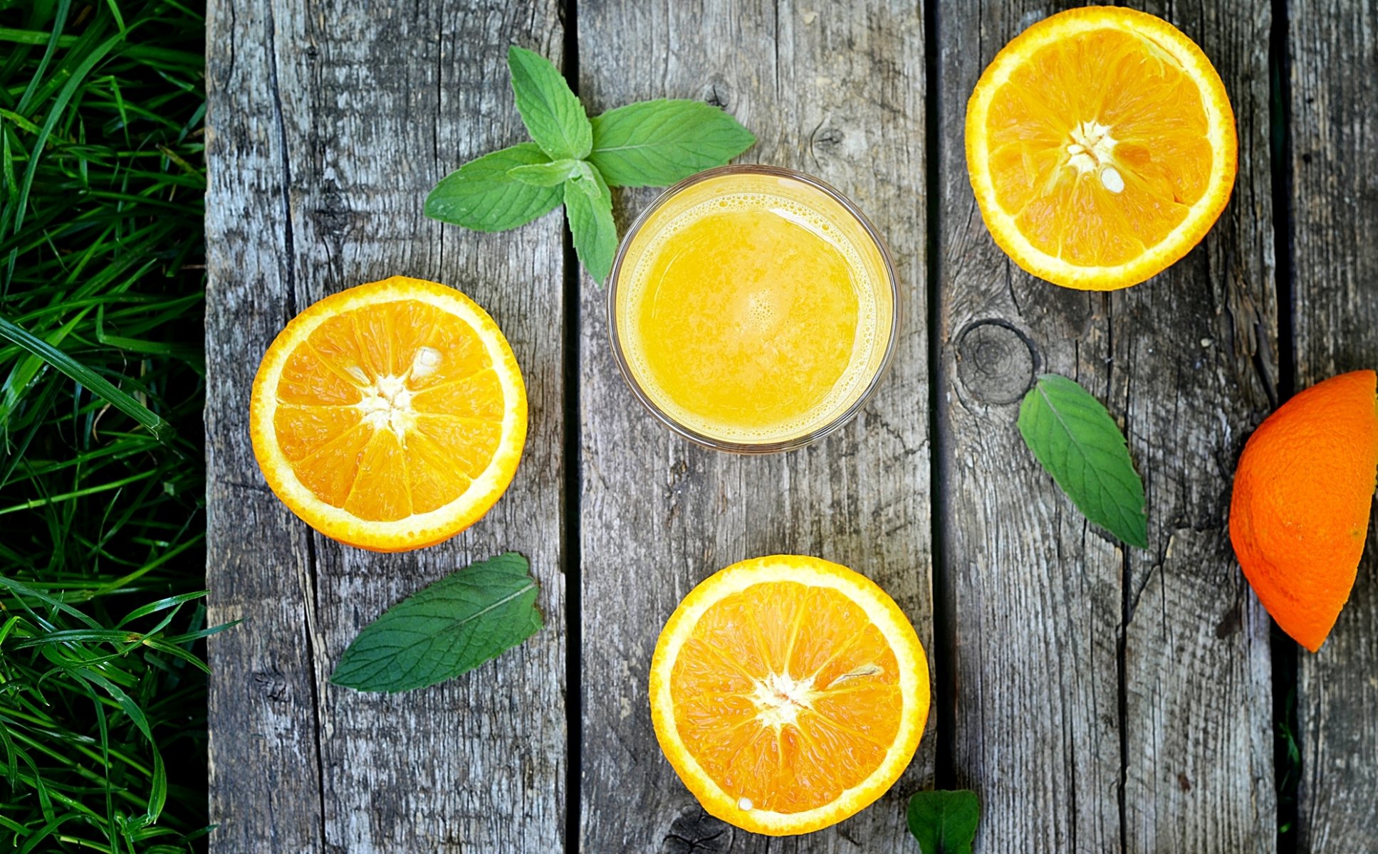 orange citrus fruits juice glass leaves grass board