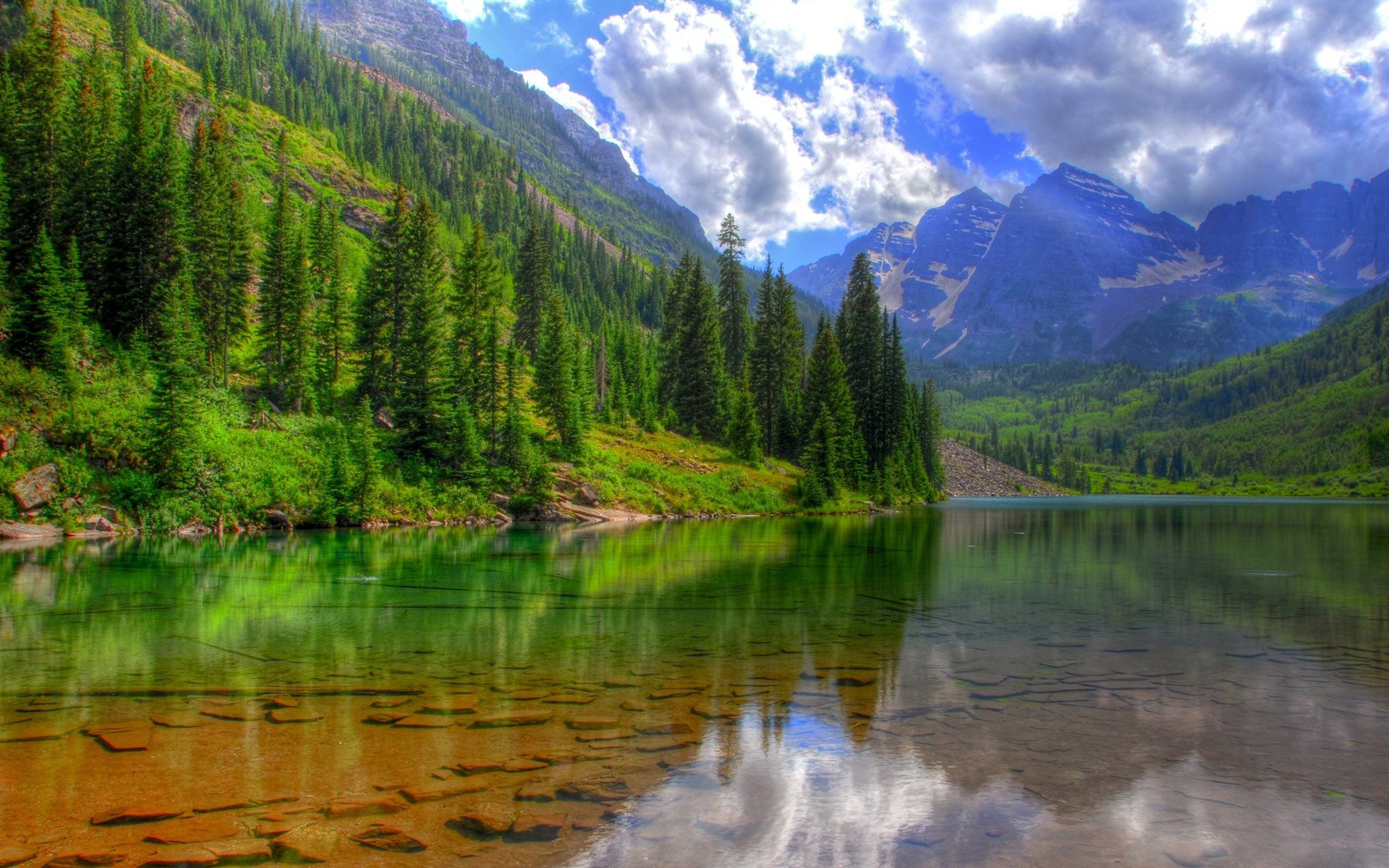 clear lake mountains clouds landscape rocky bottom