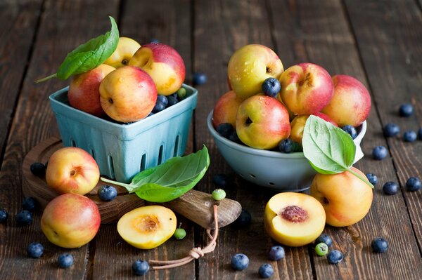 Harvest of ripe peaches and blueberries