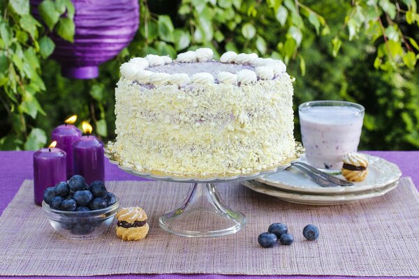 Lilac still life with cake and candles