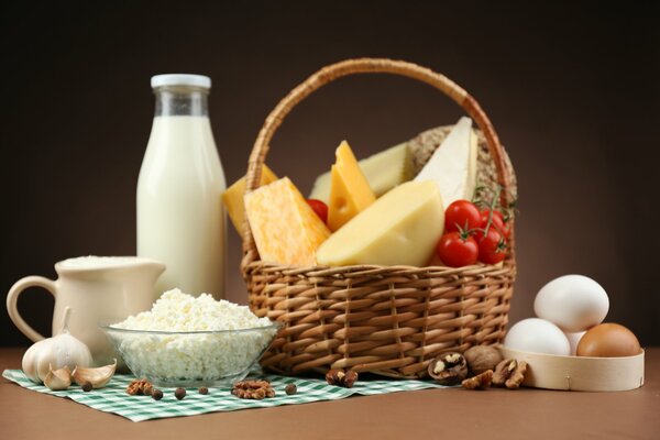 Still life with milk, cheese in a basket and eggs