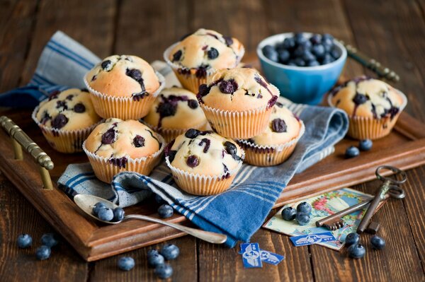 Muffins und Beeren auf einem Holztablett