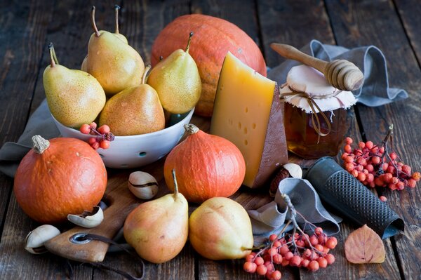 Still life of autumn fruits, honey and cheese