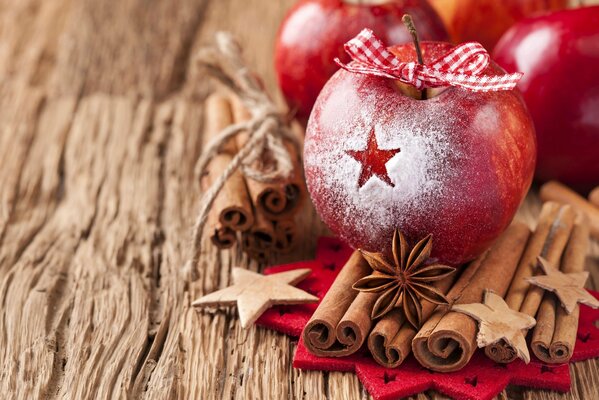 Festive red apples with a bow and winter spices