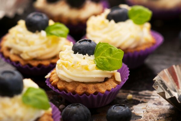 Cupcakes with cream and blueberries close-up