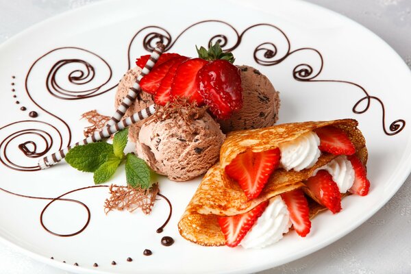 Dessert of ice cream with strawberries and pancakes with cream