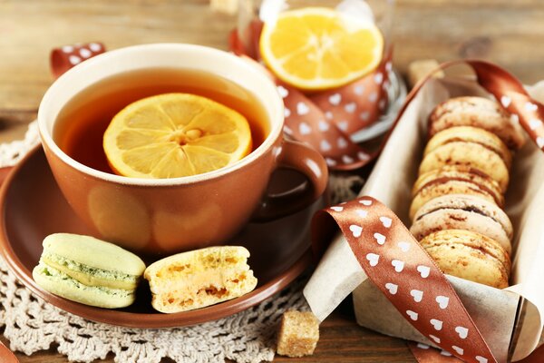 A cup of tea with lemon and French pies