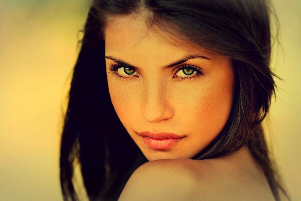 Expressive look at the photo of a brunette girl