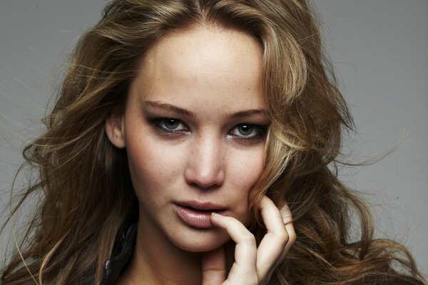 Portrait of Jennifer Lawrence with her hand near her mouth