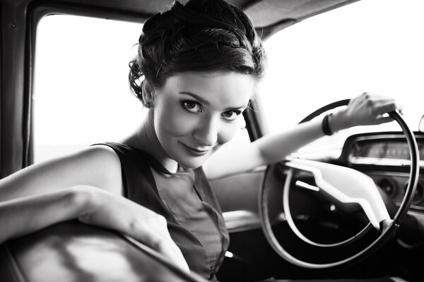 Cute girl driving a retro car