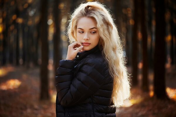 Blonde model posing in the forest