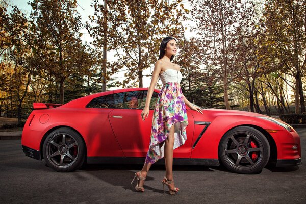 A Korean model poses against the background of a Nissan car