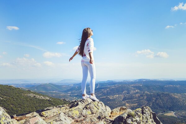 A girl in the mountains enjoys nature