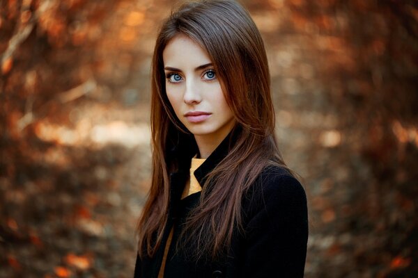 Autumn portrait with piercing gaze of a girl