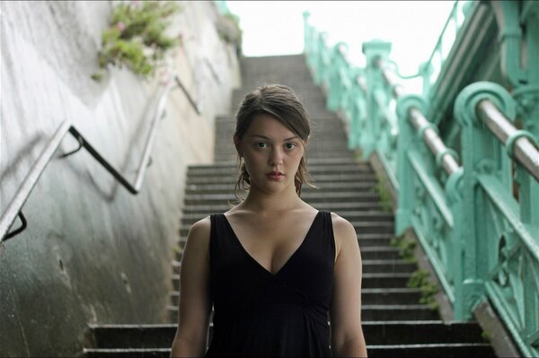 A shot from the movie Imogen with a girl on the stairs