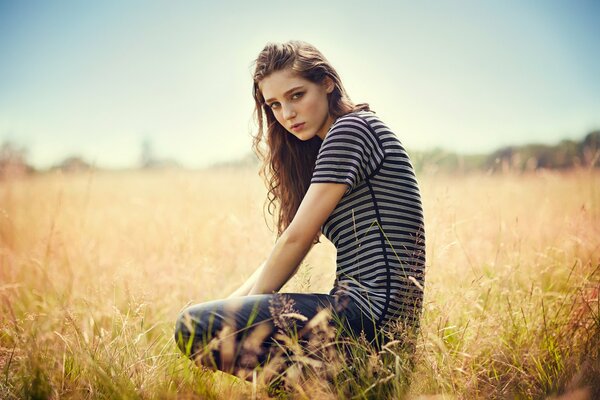 A girl in a striped jacket with curly hair