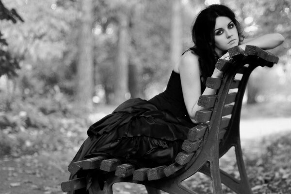 Photo nostalgique en noir et blanc-une fille sur un banc de parc