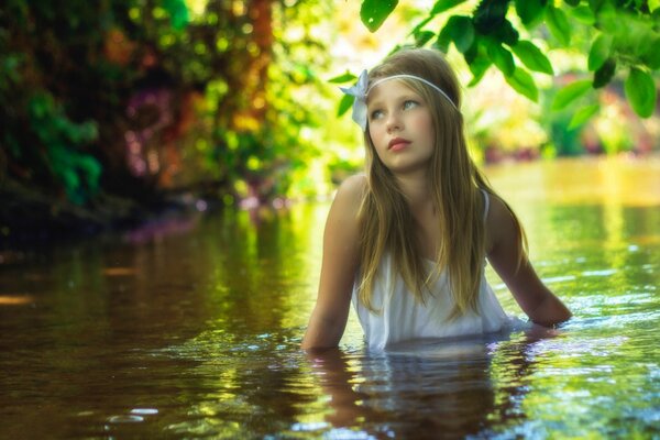 The girl is sitting in the water