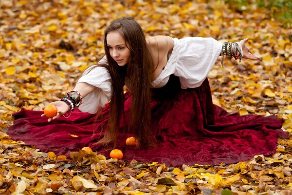 Brown-haired girl with fruit on the foliage