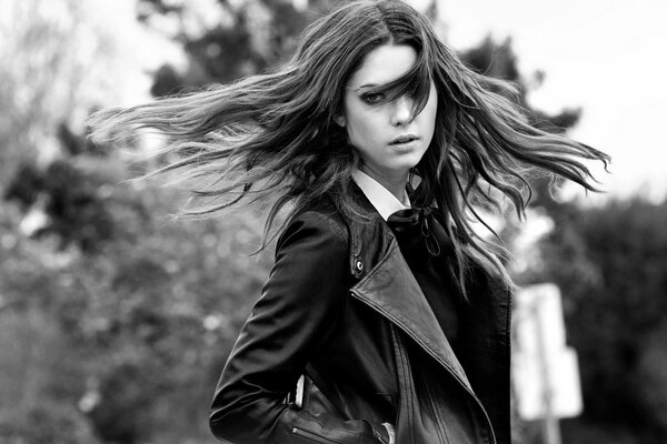 Black and white photo of a girl in a jacket with her hair down