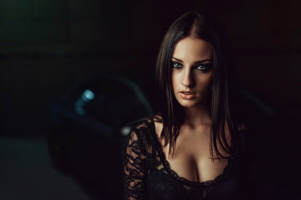 Portrait of a girl with a cleavage on a car