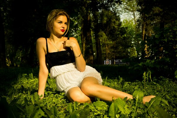 A girl in a dress on a forest background