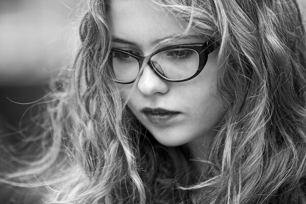 Portrait of a thoughtful girl with glasses