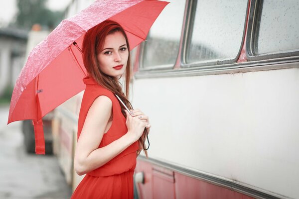 Photo of a stranger in red on the background of a bus