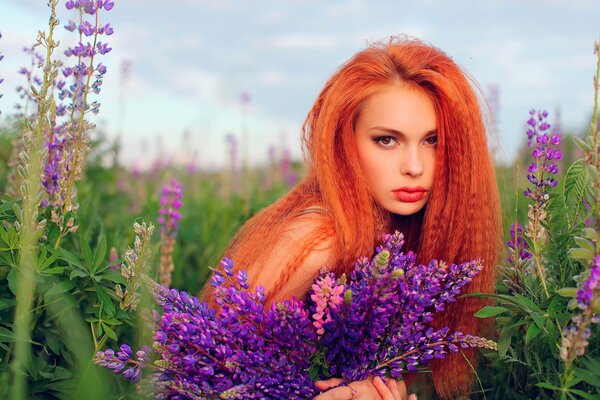 Red-haired girl with piercing eyes in flowers