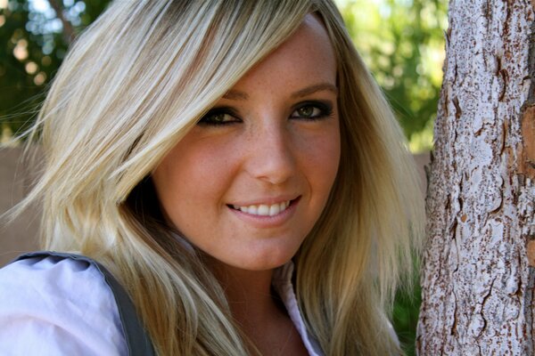 Blonde girl smiling in nature