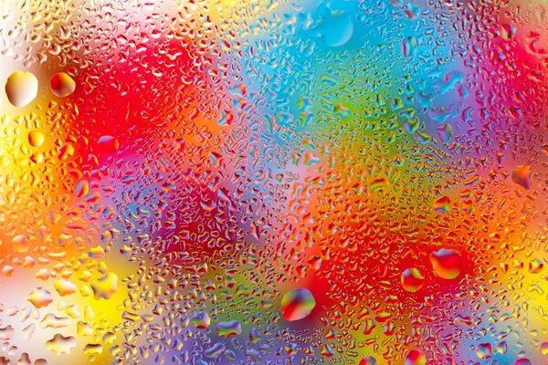 Rainbow drops on wet glass