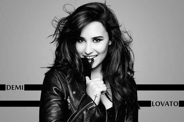 Black and white portrait of a brunette in a leather jacket, Demi Lovato