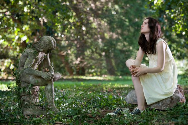 Mia Wasikowska poses next to the statue