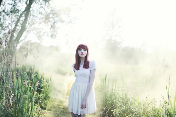 Red-haired girl in the fog
