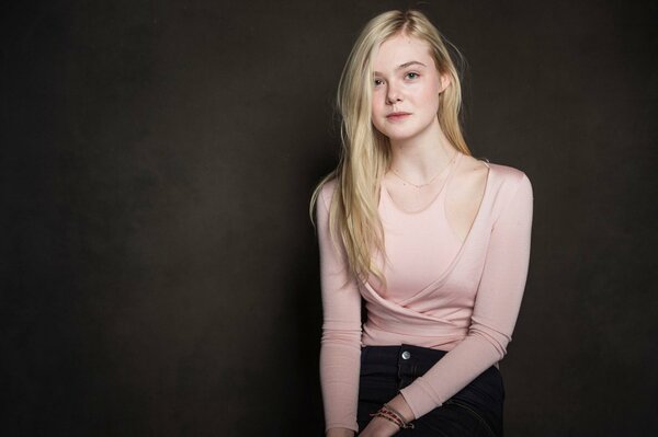 Elle Fanning in a light pink blouse
