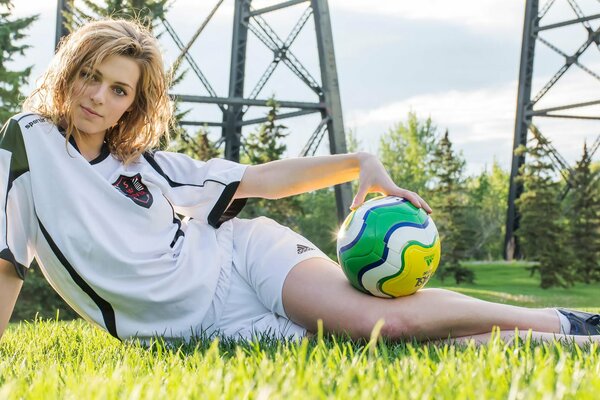 Soccer player with a ball on the green grass